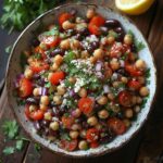 Violet Witchel Dense Bean Salad recipe featuring colorful mixed beans, cherry tomatoes, fresh herbs, and a light vinaigrette in a rustic bowl.